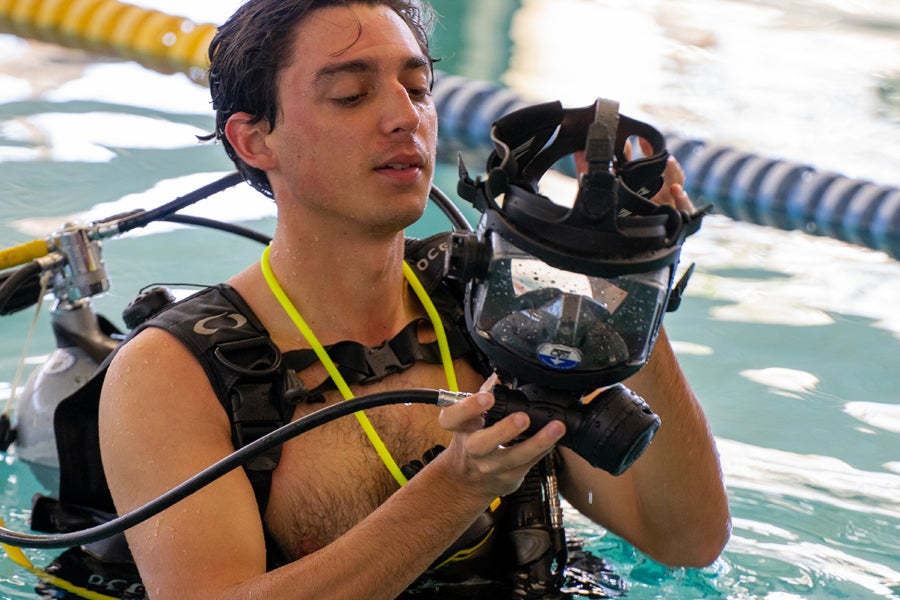 Diver examining mask