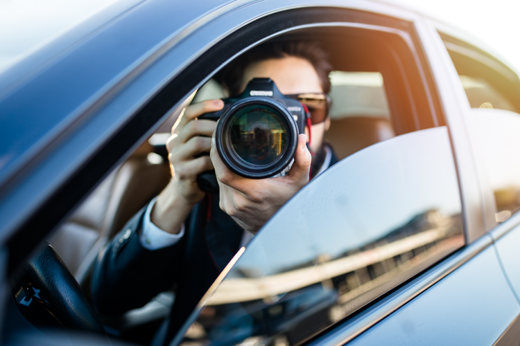 person taking photo from car window