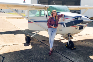 Lauren Beauchamp in front of a small plane